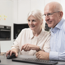 OLDER COUPLE AT LAPTOP