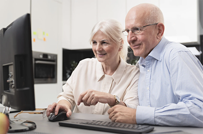 OLDER COUPLE AT LAPTOP