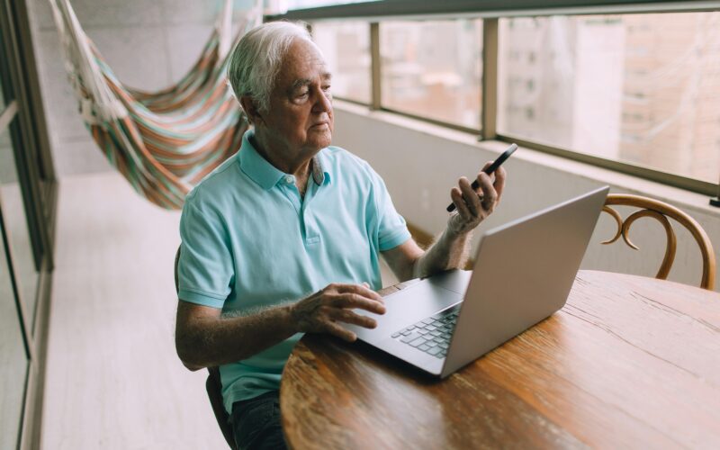 senior gent checking mobile phone