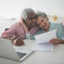 Interracial senior couple checking documents