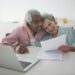 Interracial senior couple checking documents