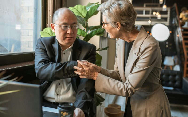 male and female seniors working at desk