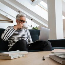 senior gentleman working on laptop at desk
