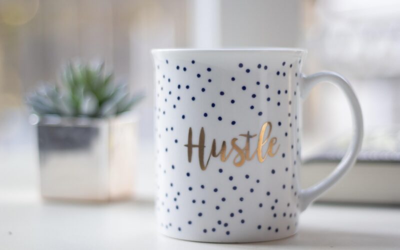 drinking mug with side hustle written on it
