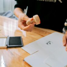 senior using stamping tool at desk