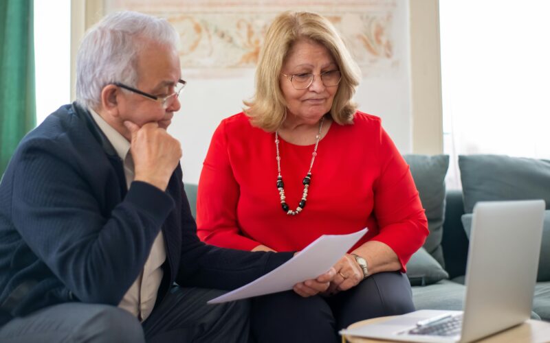 senior couple at desk