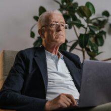 DIGNIFIED LOOKING SENIOR ON LAPTOP
