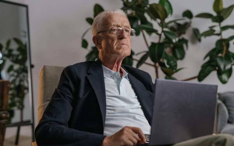 DIGNIFIED LOOKING SENIOR ON LAPTOP