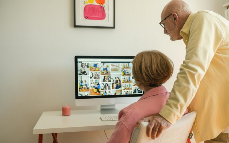 Two Seniors studying pc screen