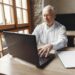 PIC OF sENIOR GENT ON LAPTOP IN HOME OFFICE