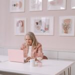 blonde senior lady working in home office