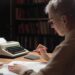 female senior working at desk writing ebook